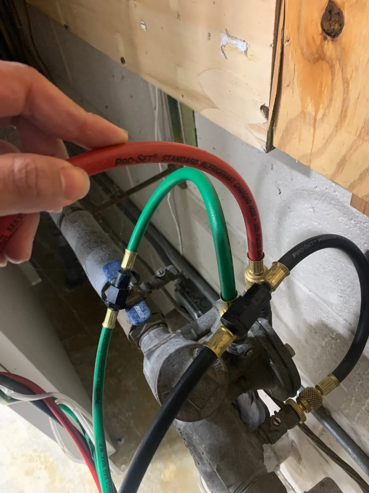 Backflow test kit hoses connected to test cocks on a device during an annual test in Rochester New York